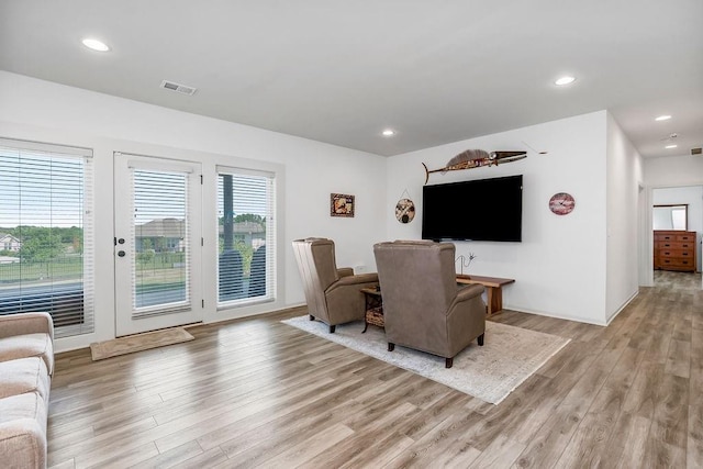 8319 Pickering St, Lenexa, KS 66227 - living area with light wood-style floors, plenty of natural light, and recessed lighting