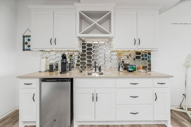 8319 Pickering St, Lenexa, KS 66227 - indoor wet bar with decorative backsplash, dishwasher, light wood-style floors, and refrigerator