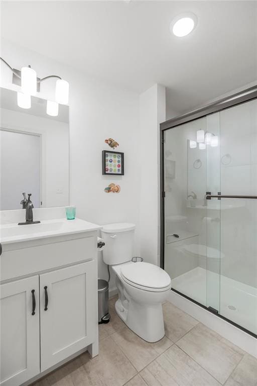 8319 Pickering St, Lenexa, KS 66227 - bathroom with vanity, a shower stall, and tile patterned floors
