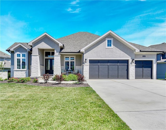 11126 W 172nd Ter, Overland Park, KS 66221 - view of front of house featuring stucco siding, a garage, concrete driveway, a front yard, and stone siding