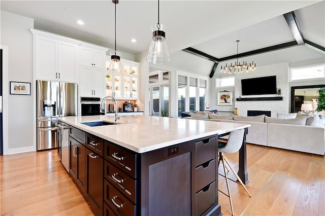 11126 W 172nd Ter, Overland Park, KS 66221 - kitchen with appliances with stainless steel finishes, plenty of natural light, a kitchen bar, white cabinetry, and recessed lighting