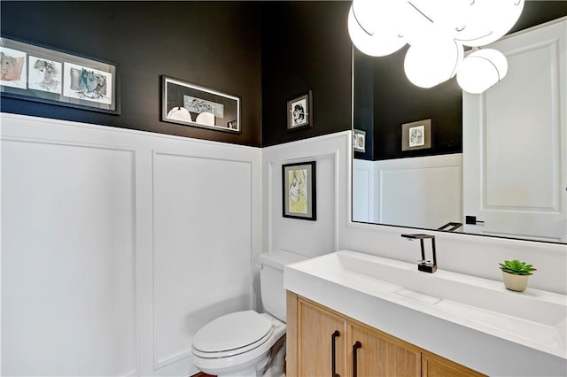 11126 W 172nd Ter, Overland Park, KS 66221 - bathroom featuring a decorative wall, vanity, and wainscoting