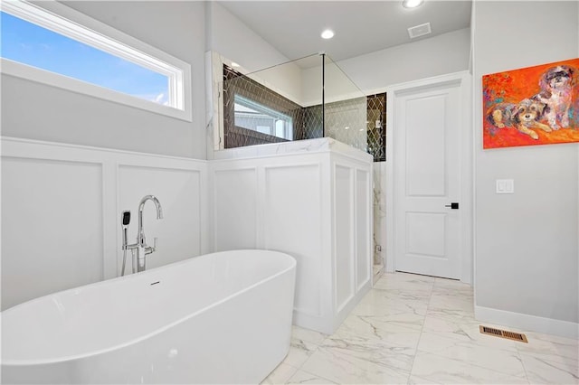 11126 W 172nd Ter, Overland Park, KS 66221 - bathroom with a decorative wall, marble finish flooring, a freestanding tub, a walk in shower, and recessed lighting