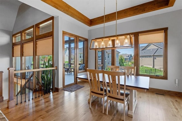 8856 Freedom St, Lenexa, KS 66227 - dining room with plenty of natural light, hardwood / wood-style floors, and a raised ceiling