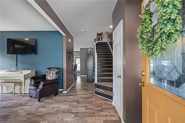 1210 NW Persimmon Dr, Grain Valley, MO 64029 - foyer entrance featuring stairs, wood finished floors, and a textured ceiling