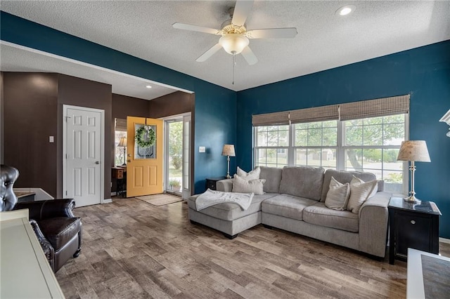 1210 NW Persimmon Dr, Grain Valley, MO 64029 - living room featuring ceiling fan, wood finished floors, a textured ceiling, and recessed lighting