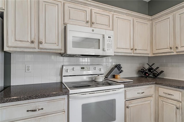 1210 NW Persimmon Dr, Grain Valley, MO 64029 - kitchen with white appliances, decorative backsplash, and dark countertops