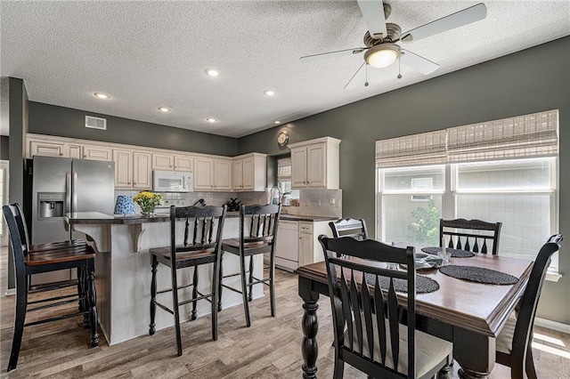 1210 NW Persimmon Dr, Grain Valley, MO 64029 - dining space with light wood finished floors, a textured ceiling, ceiling fan, and recessed lighting