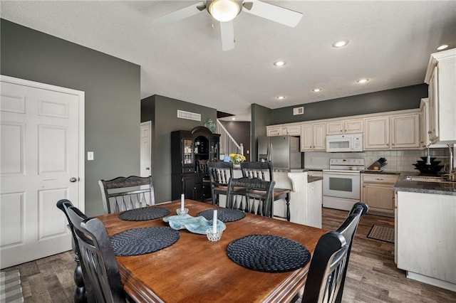 1210 NW Persimmon Dr, Grain Valley, MO 64029 - dining space with ceiling fan, wood finished floors, recessed lighting, and stairway