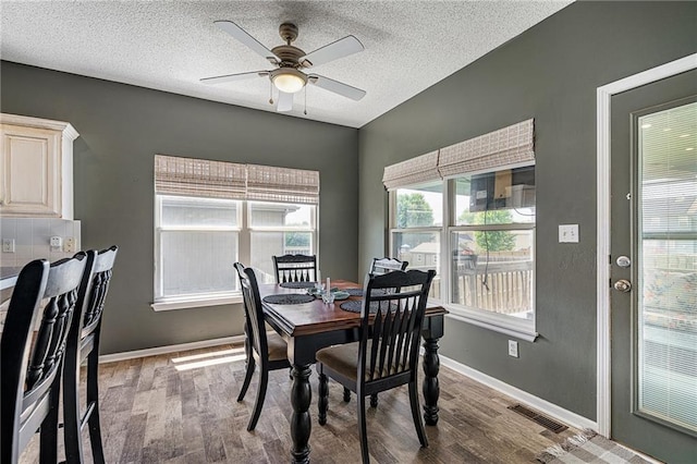 1210 NW Persimmon Dr, Grain Valley, MO 64029 - dining area featuring wood finished floors, a ceiling fan, and a textured ceiling