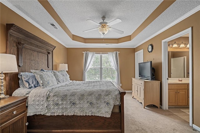 1210 NW Persimmon Dr, Grain Valley, MO 64029 - bedroom featuring a raised ceiling, light carpet, a textured ceiling, ensuite bathroom, and a ceiling fan