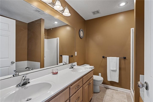 1210 NW Persimmon Dr, Grain Valley, MO 64029 - full bath with a walk in shower, double vanity, a textured ceiling, and tile patterned flooring