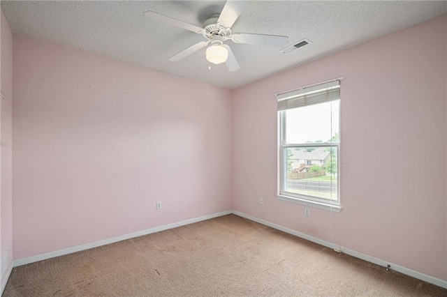 1210 NW Persimmon Dr, Grain Valley, MO 64029 - spare room featuring light colored carpet, a textured ceiling, and ceiling fan