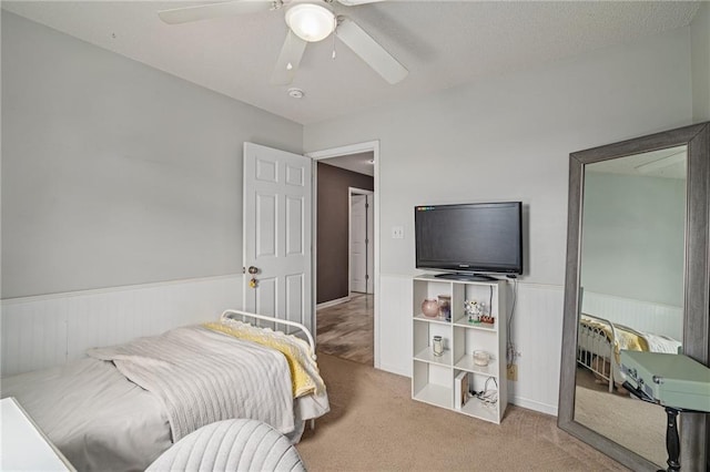 1210 NW Persimmon Dr, Grain Valley, MO 64029 - carpeted bedroom featuring wainscoting and ceiling fan