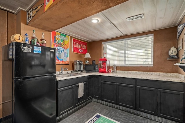 1210 NW Persimmon Dr, Grain Valley, MO 64029 - kitchen with black appliances, wooden ceiling, and dark cabinets