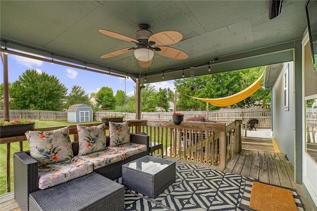 1210 NW Persimmon Dr, Grain Valley, MO 64029 - deck with a storage shed, a fenced backyard, an outdoor hangout area, and a ceiling fan