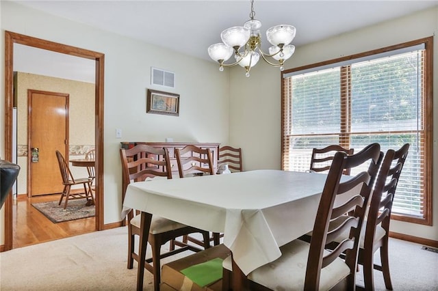 3038 Weaver School Rd, Odessa, MO 64076 - dining room featuring plenty of natural light, a chandelier, and carpet flooring