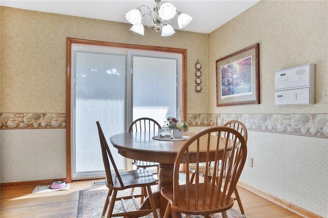 3038 Weaver School Rd, Odessa, MO 64076 - dining space featuring light wood-style floors, wallpapered walls, and a chandelier
