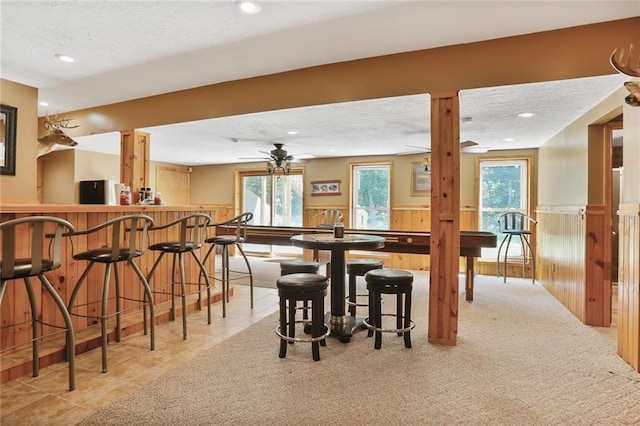 3038 Weaver School Rd, Odessa, MO 64076 - dining area with bar with sink, recessed lighting, a textured ceiling, a ceiling fan, and a wainscoted wall