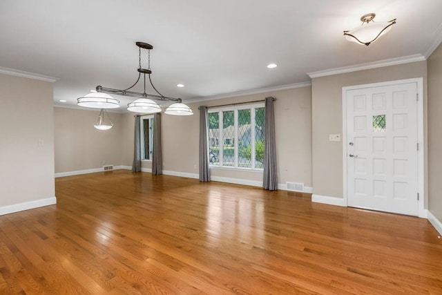 7718 W 100th St, Overland Park, KS 66212 - entrance foyer with crown molding, light wood-style flooring, and recessed lighting