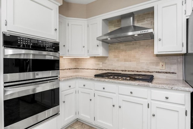 7718 W 100th St, Overland Park, KS 66212 - kitchen featuring wall chimney range hood, stainless steel appliances, and white cabinetry
