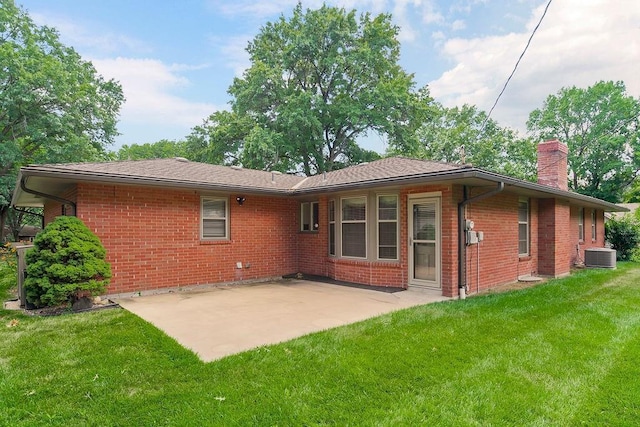7718 W 100th St, Overland Park, KS 66212 - rear view of property with a chimney, brick siding, a yard, and a patio area