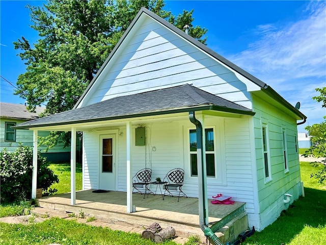 14364 N Bay St, Mercer, MO 64661 - back of property featuring a porch, a shingled roof, and a lawn