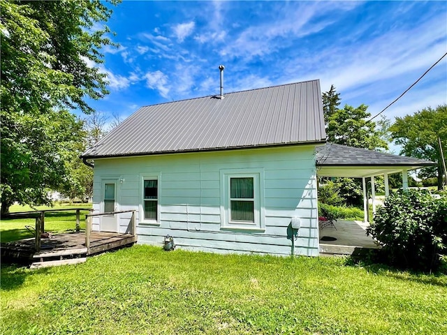 14364 N Bay St, Mercer, MO 64661 - back of house featuring a deck, a yard, and a metal roof