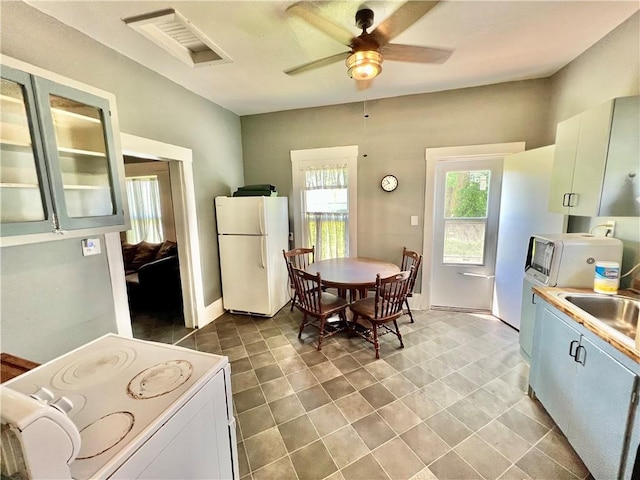 14364 N Bay St, Mercer, MO 64661 - kitchen with white appliances, ceiling fan, light countertops, and glass insert cabinets
