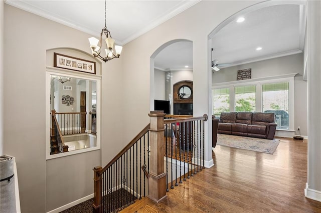 18501 S Butternut St W, Gardner, KS 66030 - stairway featuring a ceiling fan, arched walkways, wood finished floors, crown molding, and a chandelier