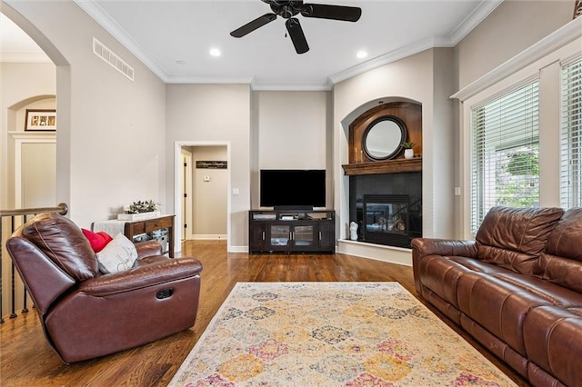 18501 S Butternut St W, Gardner, KS 66030 - living room featuring wood finished floors, crown molding, a ceiling fan, arched walkways, and recessed lighting