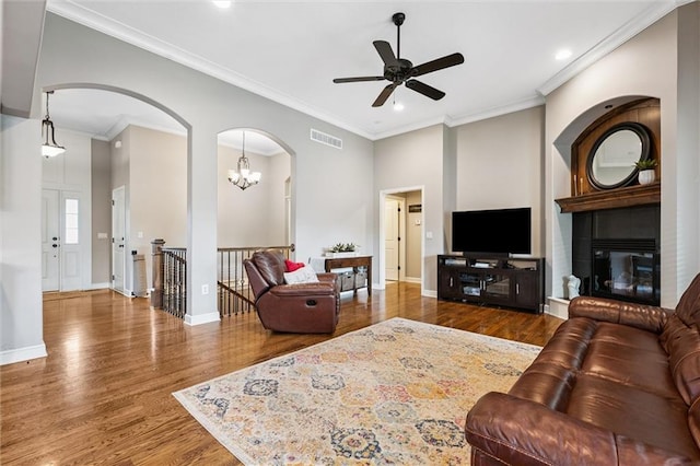 18501 S Butternut St W, Gardner, KS 66030 - living area with wood finished floors, ceiling fan, recessed lighting, ornamental molding, and arched walkways