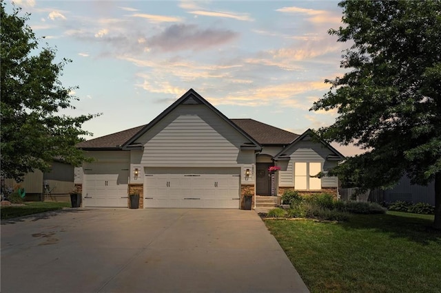 18501 S Butternut St W, Gardner, KS 66030 - view of front of house featuring concrete driveway, an attached garage, a front lawn, and stone siding