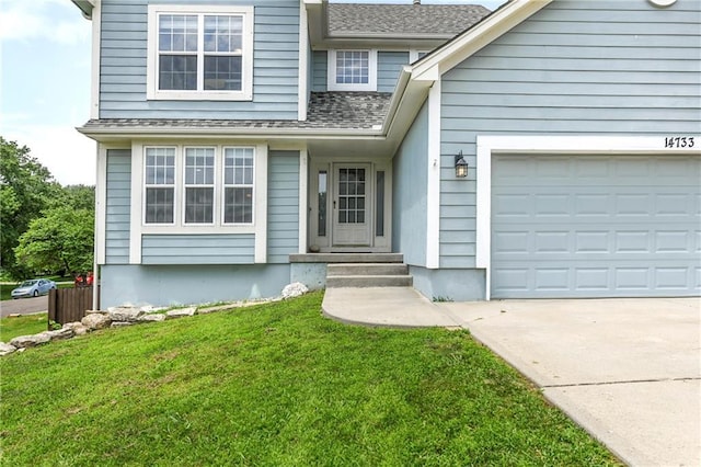 14733 Hickory Dr, Bonner Springs, KS 66012 - view of front of home with driveway, a front yard, a shingled roof, and an attached garage