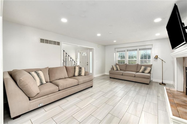 14733 Hickory Dr, Bonner Springs, KS 66012 - living room with recessed lighting, stairs, and a fireplace with raised hearth