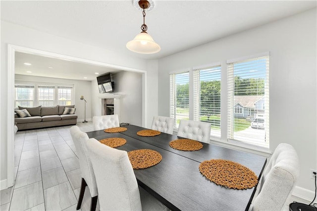 14733 Hickory Dr, Bonner Springs, KS 66012 - dining space featuring baseboards and a tiled fireplace