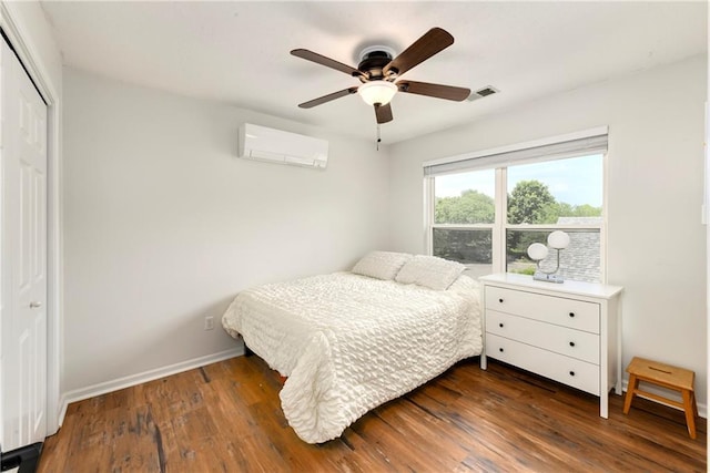 14733 Hickory Dr, Bonner Springs, KS 66012 - bedroom featuring a wall mounted AC, wood finished floors, a closet, and ceiling fan