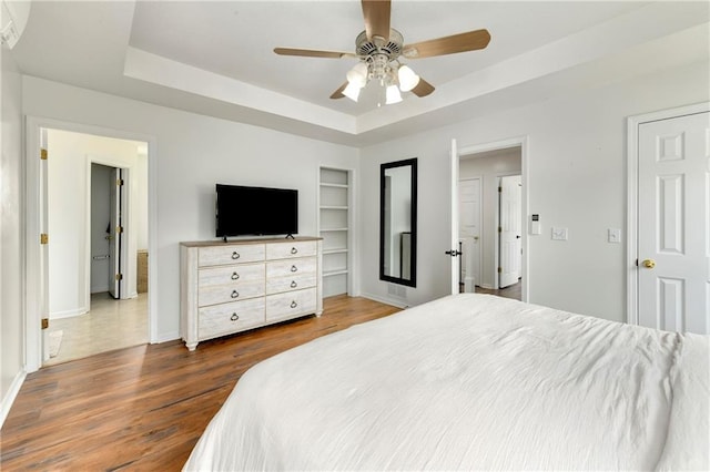 14733 Hickory Dr, Bonner Springs, KS 66012 - bedroom with a tray ceiling, dark wood-style floors, and a ceiling fan