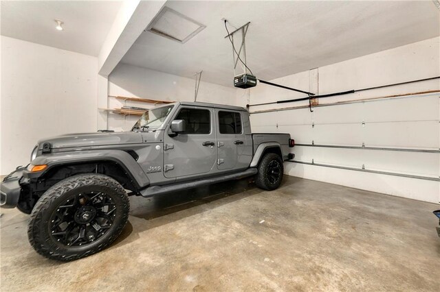 14733 Hickory Dr, Bonner Springs, KS 66012 - garage featuring a garage door opener
