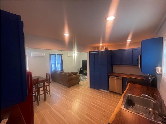 1807 Dodds Camp Rd, Climax Springs, MO 65324 - kitchen featuring stainless steel appliances, a wall mounted air conditioner, blue cabinetry, light wood finished floors, and recessed lighting