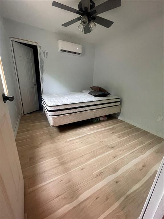 1807 Dodds Camp Rd, Climax Springs, MO 65324 - bedroom featuring a wall mounted air conditioner, wood finished floors, and a ceiling fan
