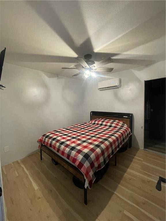 1807 Dodds Camp Rd, Climax Springs, MO 65324 - bedroom with a wall mounted air conditioner, wood finished floors, and ceiling fan
