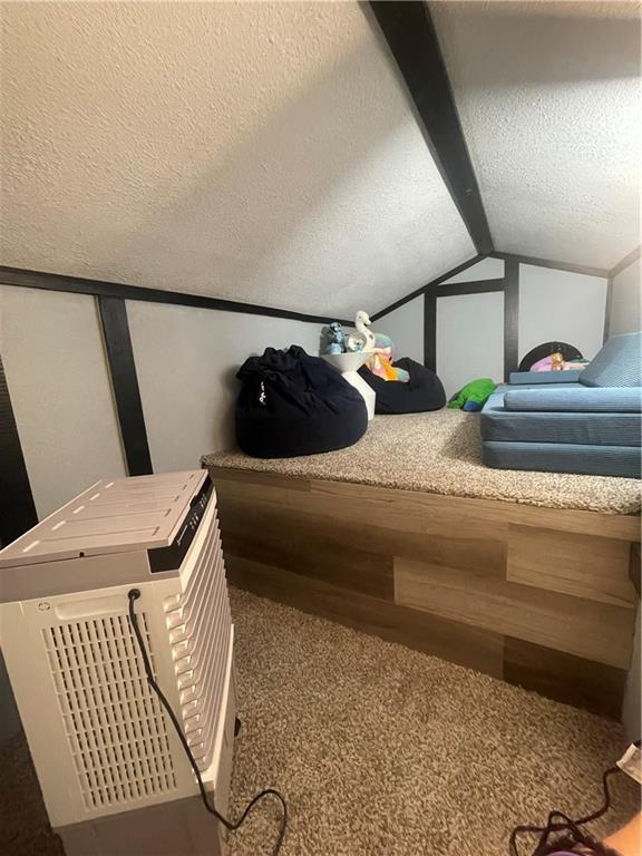 1807 Dodds Camp Rd, Climax Springs, MO 65324 - bedroom featuring carpet floors, lofted ceiling, and a textured ceiling