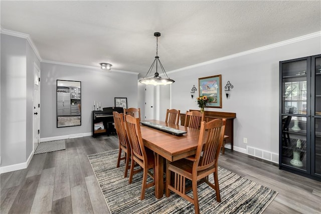 1410 Vilas St, Leavenworth, KS 66048 - dining space featuring dark wood finished floors and ornamental molding