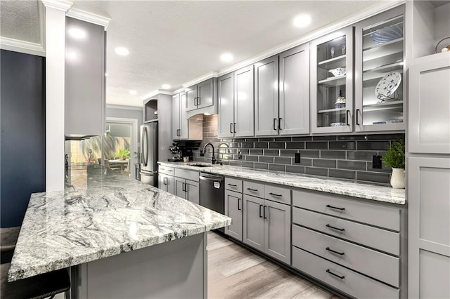 1410 Vilas St, Leavenworth, KS 66048 - kitchen with freestanding refrigerator, gray cabinetry, tasteful backsplash, light stone counters, and recessed lighting
