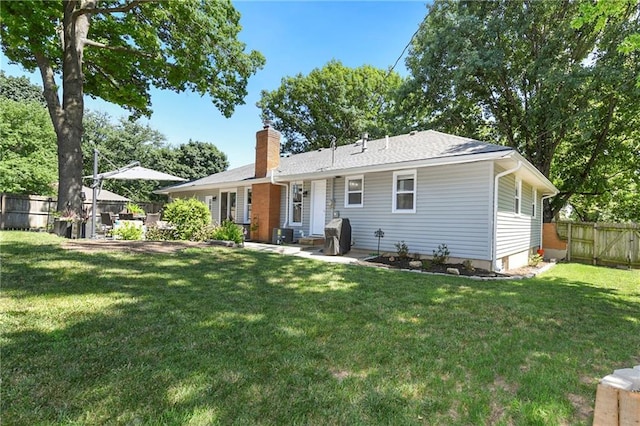 1410 Vilas St, Leavenworth, KS 66048 - rear view of property featuring a chimney and a fenced backyard