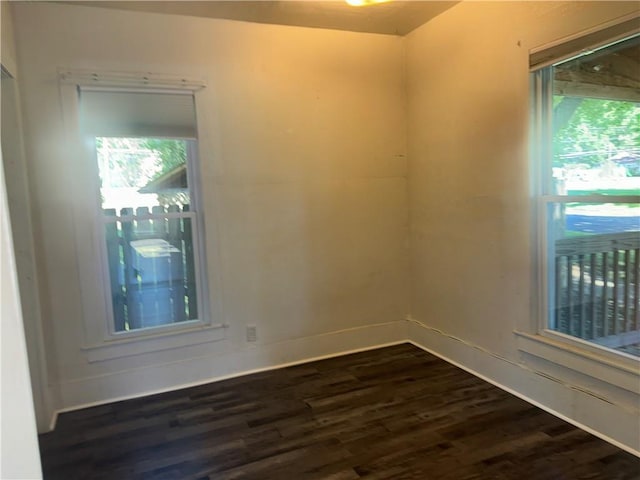 310 E 3rd Ave, Garnett, KS 66032 - empty room featuring dark wood finished floors and healthy amount of natural light