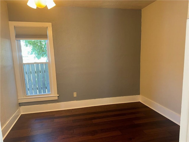 310 E 3rd Ave, Garnett, KS 66032 - empty room featuring dark wood-style floors and baseboards
