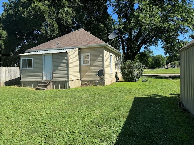 310 E 3rd Ave, Garnett, KS 66032 - back of property featuring entry steps and a shingled roof