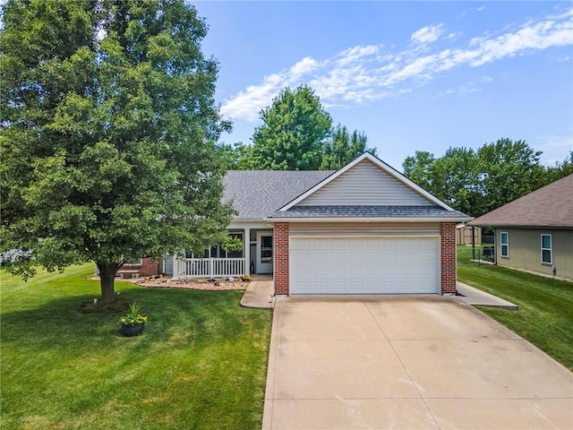 903 Howenstein St, Cameron, MO 64429 - view of front facade featuring a garage, a front lawn, brick siding, and driveway